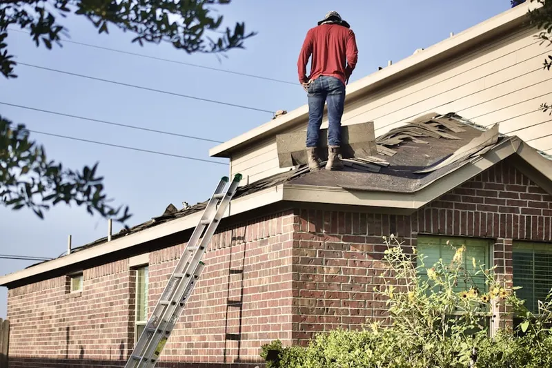 Professional roofer working on a residential roof in Downtown Lynn